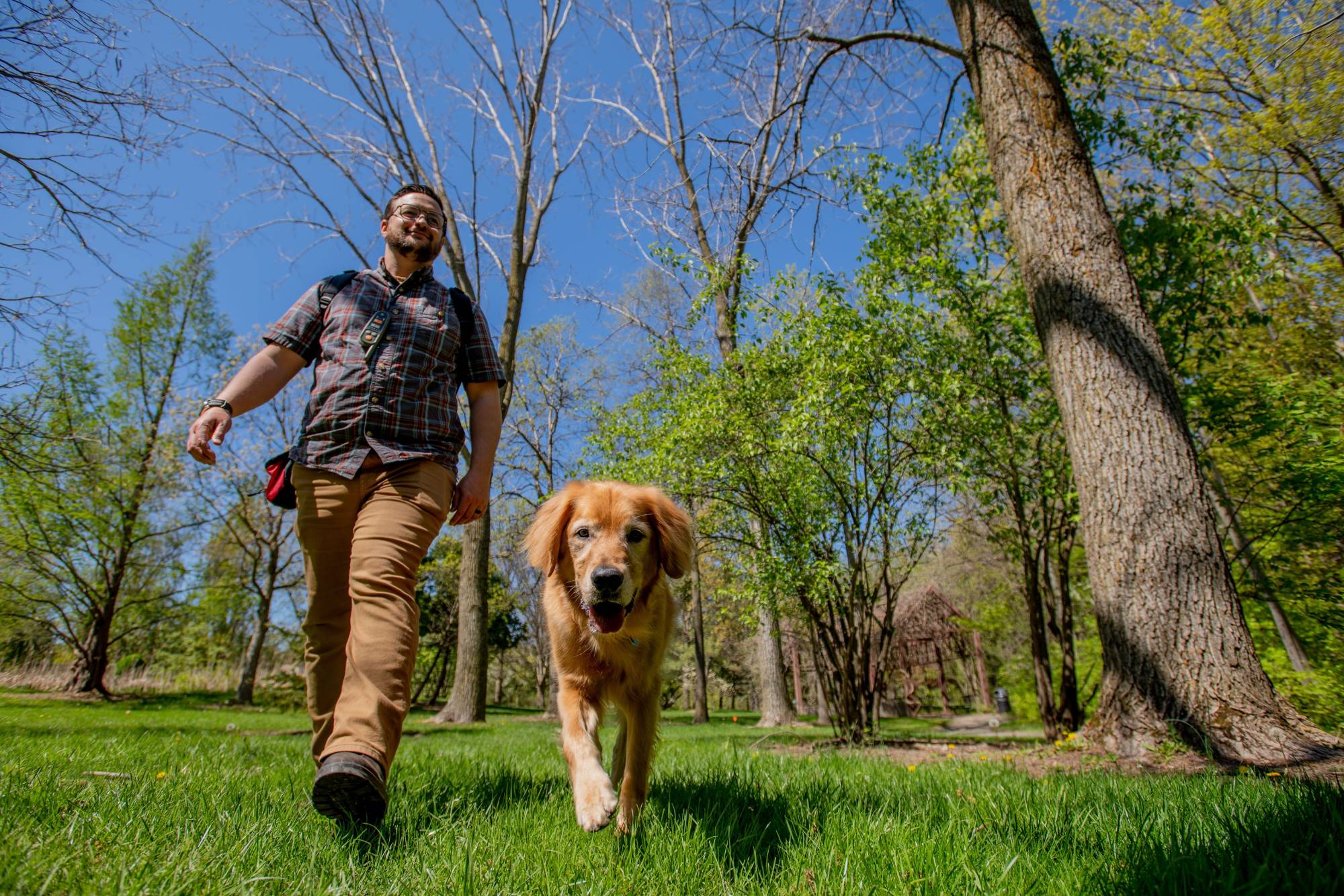 Nick and Louie walk in the GVSU Arboretum
